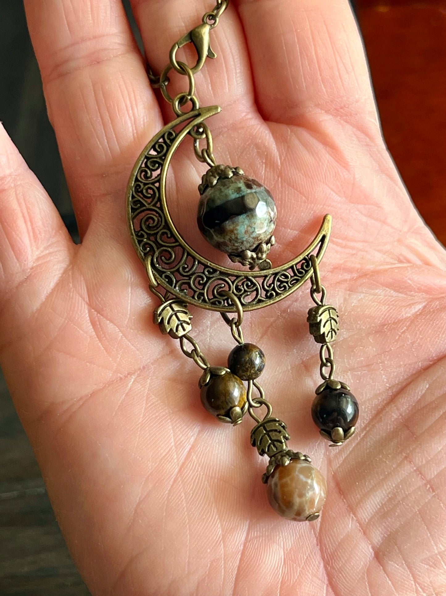 Bronze moon with leafy detailing