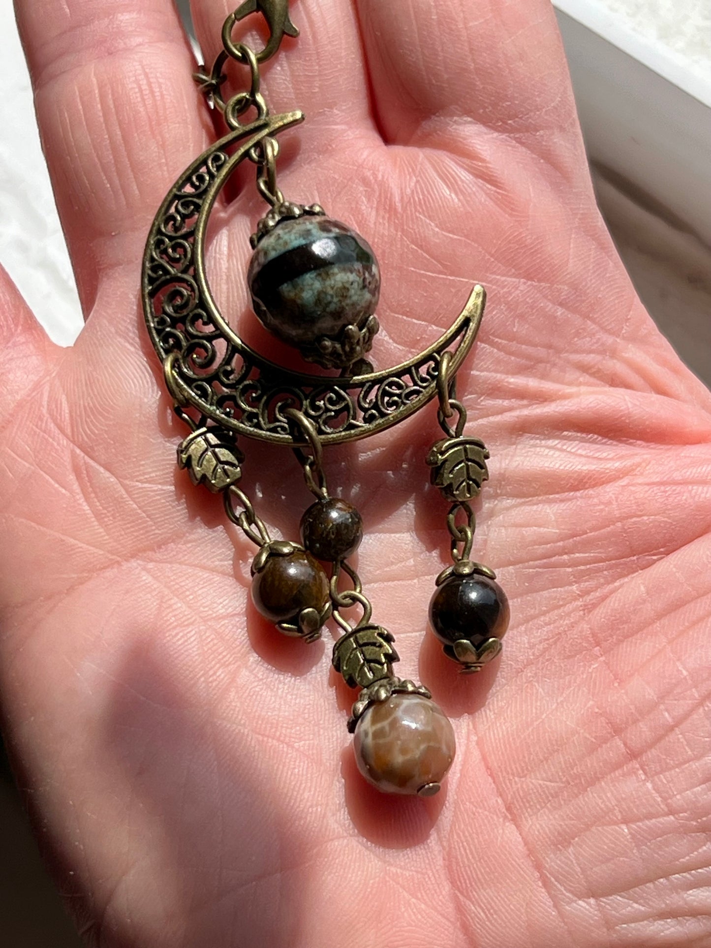 Bronze moon with leafy detailing