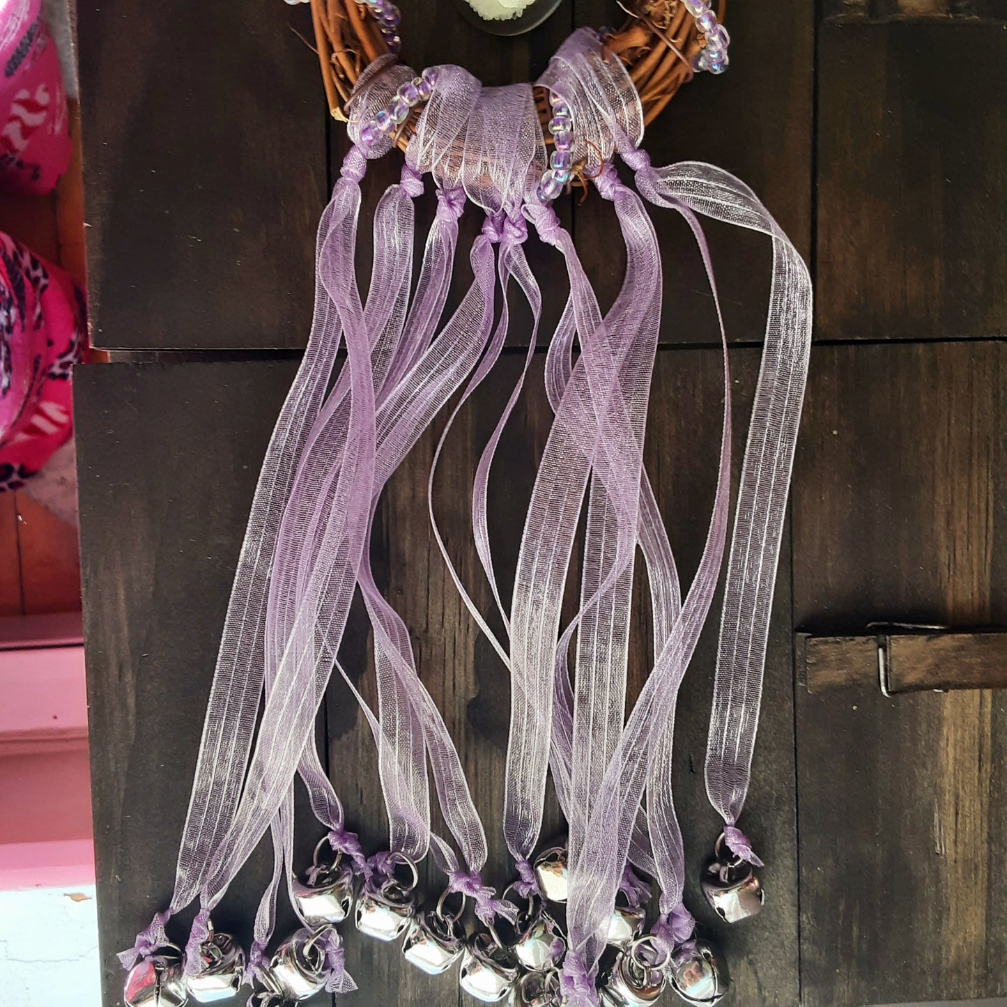 Witch bells with real flowers and purple ribbon