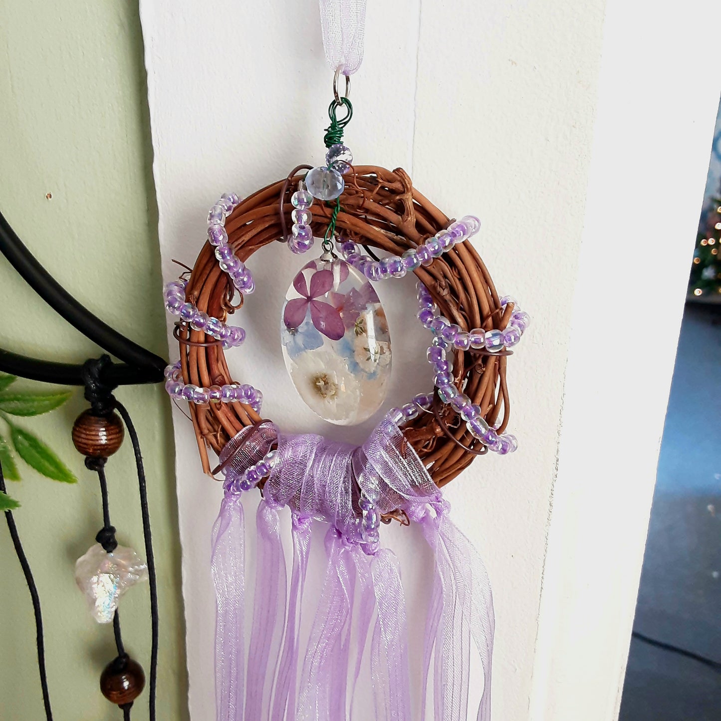 Witch bells with real flowers and purple ribbon