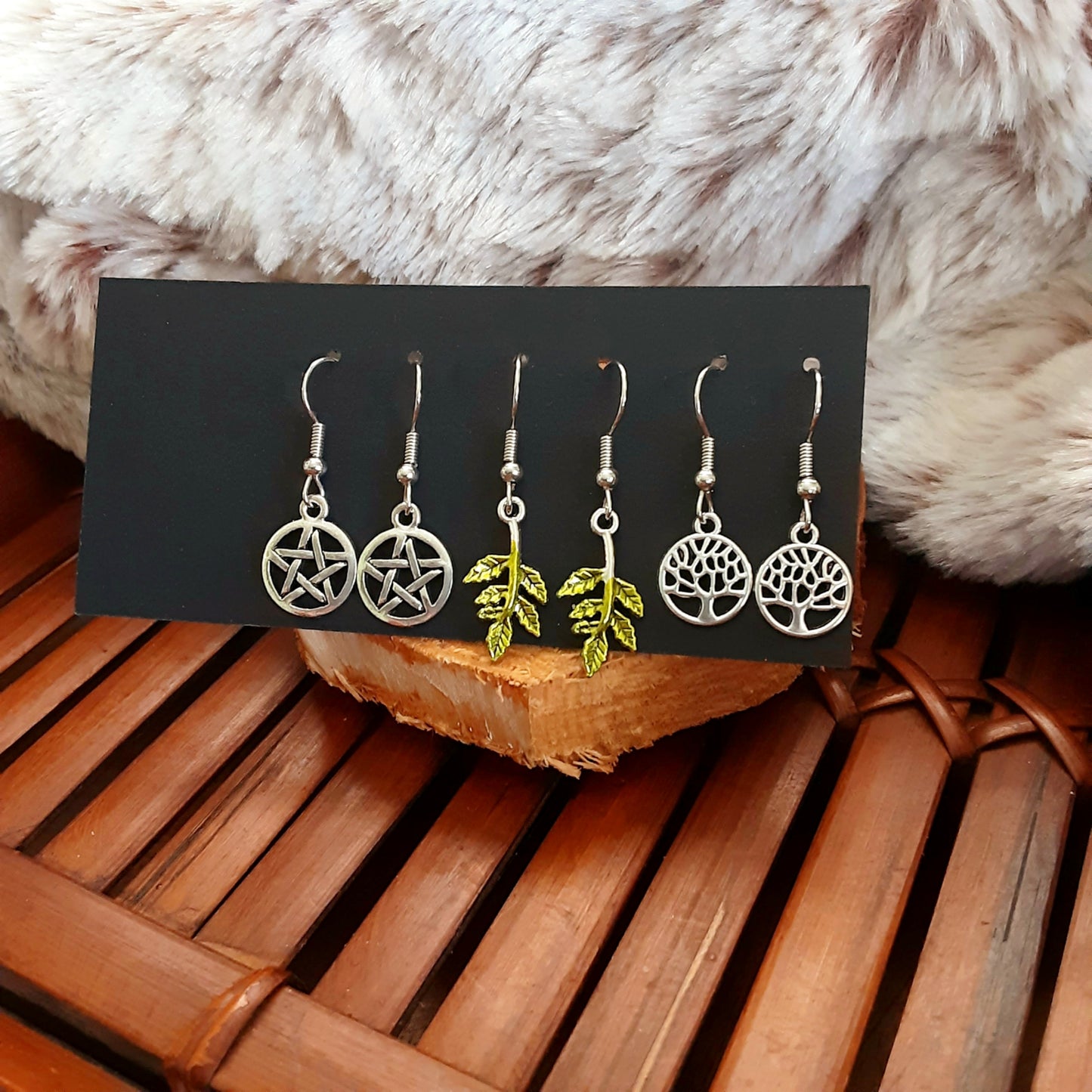 Earrings set with pentacles, trees and leaves